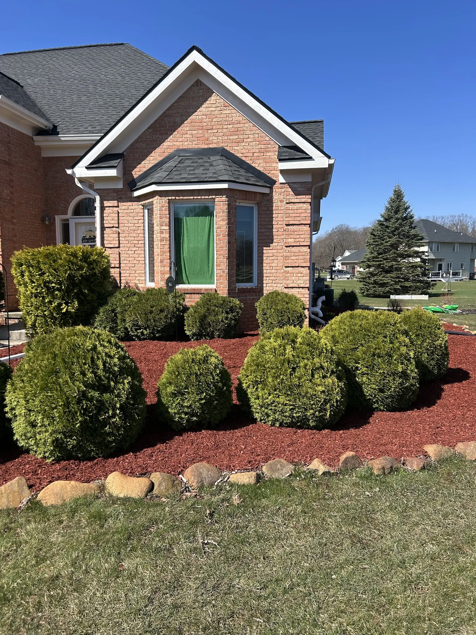 Trimmed red bushes with mulch in Milford, MI